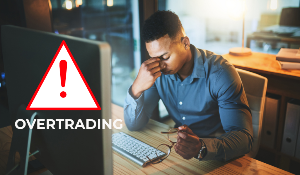 Homem estressado olhando para computador sobre overtrading.